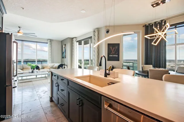 a kitchen with a sink and living room view
