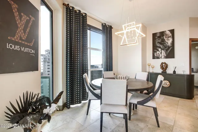 a view of a dining room with furniture and window