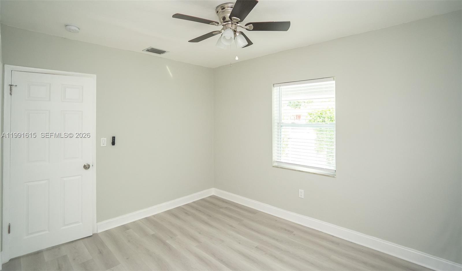 2230 Southwest 60th Court Miami, FL 33155 - Photo 34 of 35 an empty room with a window and a ceiling fan