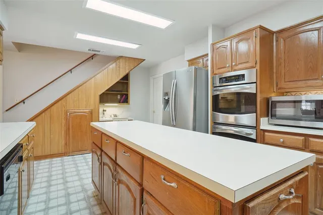 a kitchen with a stove and a refrigerator