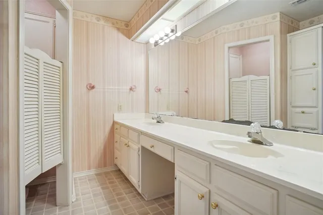 a bathroom with a double vanity sink and a mirror