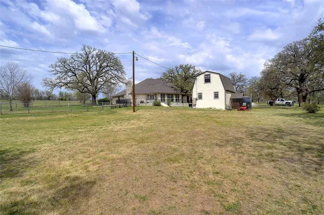 a view of a yard with a house in the background