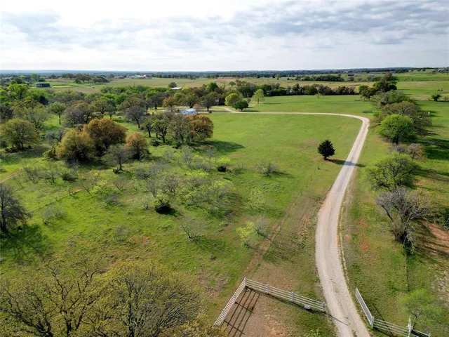 an aerial view of a house with a lake view