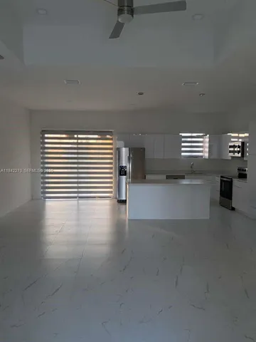 a view of a livingroom with furniture and an empty room