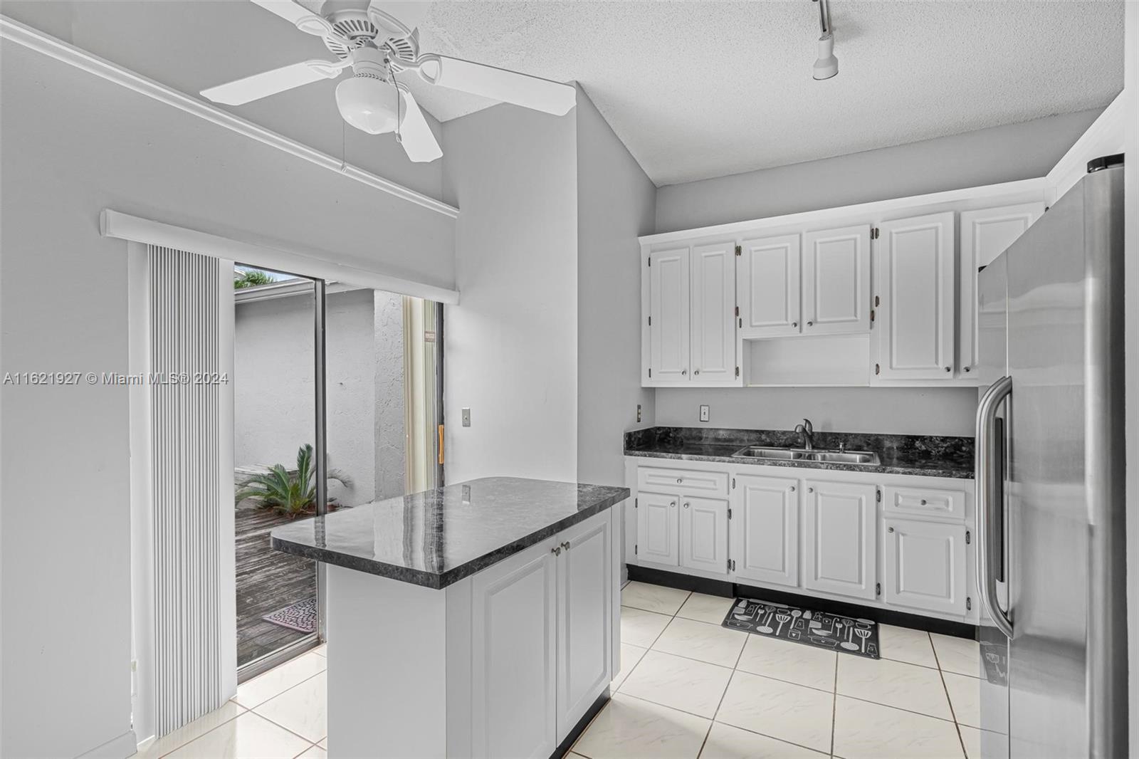 6604 Southwest 152nd Place, Unit 2604 Miami, FL 33193 - Photo 11 of 27 a kitchen with stainless steel appliances granite countertop a stove a sink and a refrigerator