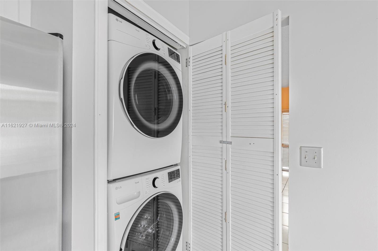 6604 Southwest 152nd Place, Unit 2604 Miami, FL 33193 - Photo 13 of 27 a utility room with dryer and washer
