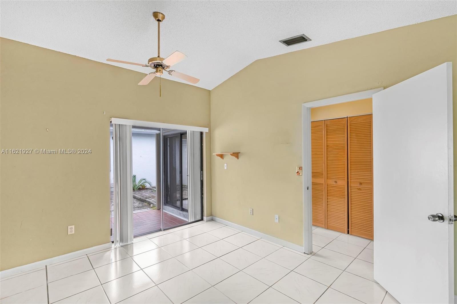 6604 Southwest 152nd Place, Unit 2604 Miami, FL 33193 - Photo 15 of 27 a view of an empty room with window and chandelier fan