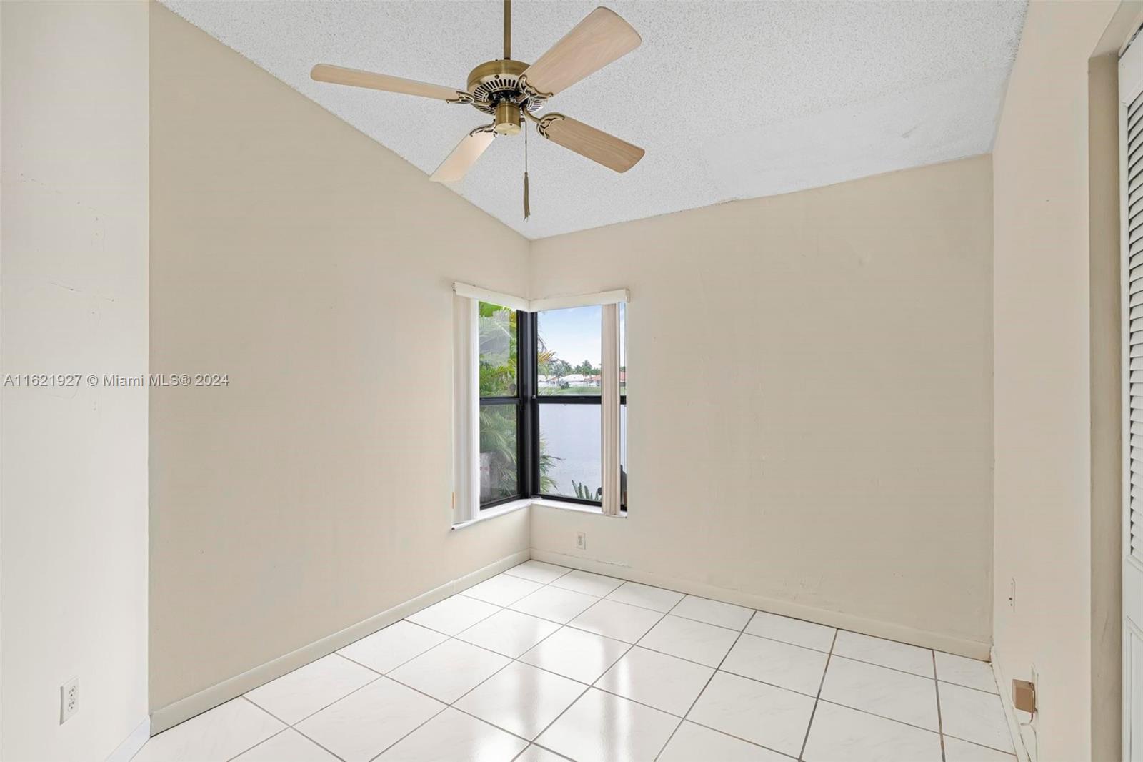6604 Southwest 152nd Place, Unit 2604 Miami, FL 33193 - Photo 17 of 27 a view of an empty room with a window