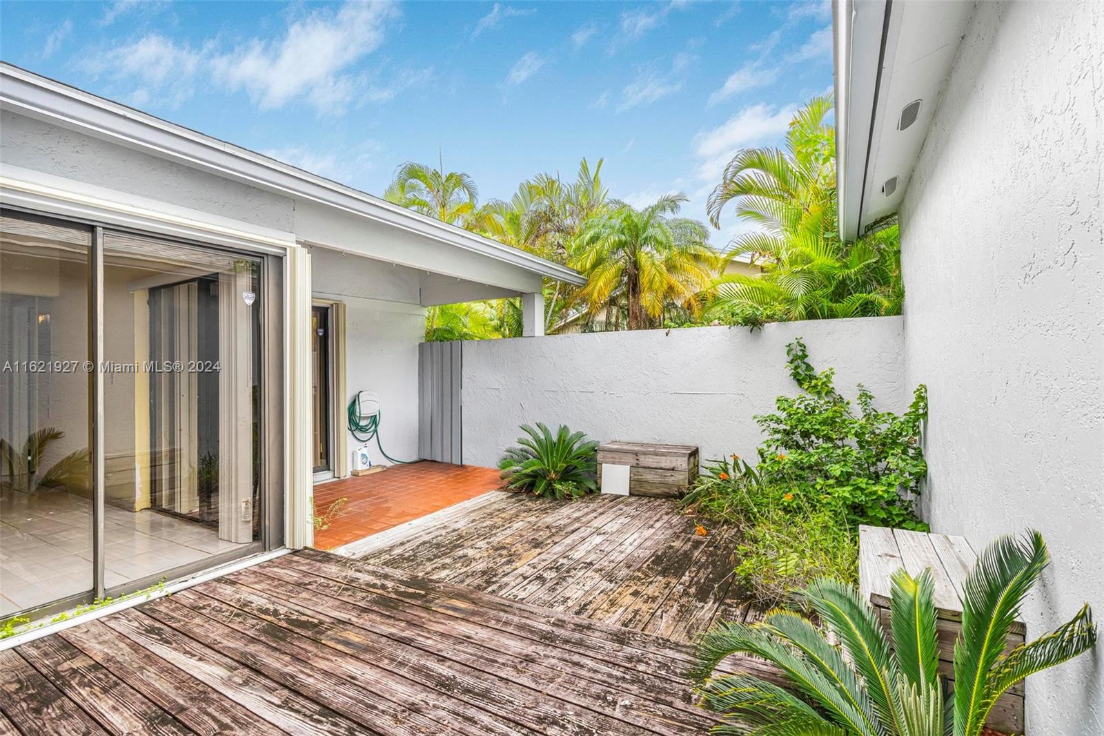 6604 Southwest 152nd Place, Unit 2604 Miami, FL 33193 - Photo 18 of 27 a balcony with flowers and wooden floor