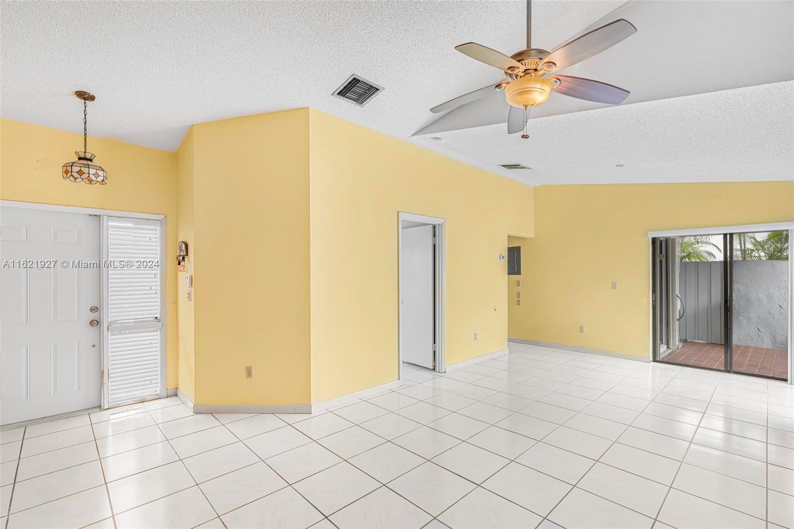 6604 Southwest 152nd Place, Unit 2604 Miami, FL 33193 - Photo 7 of 27 a view of a livingroom with a chandelier fan