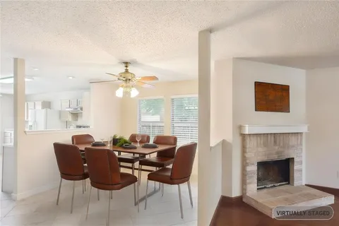 a living room with furniture a table and a fireplace