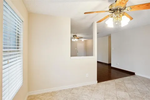 a view of a hallway with a chandelier fan and wooden floor