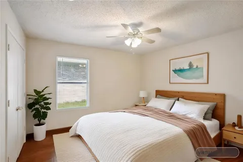 a bedroom with a large bed and a window