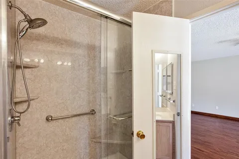 a bathroom with a shower and a glass door