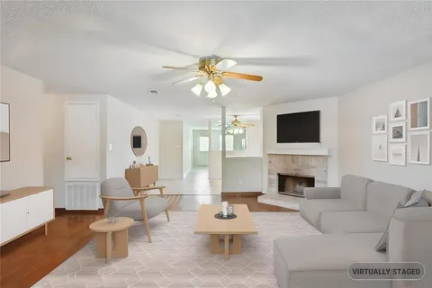 a living room with furniture fireplace and a flat screen tv