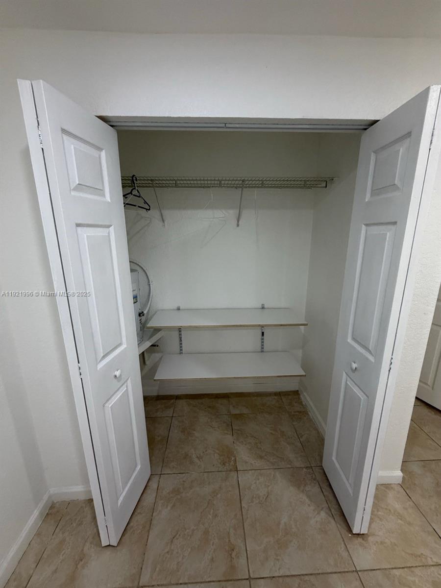 830 Southwest 6th Street, Unit B Hallandale Beach, FL 33009 - Photo 7 of 11 a view of storage and utility room with a fireplace