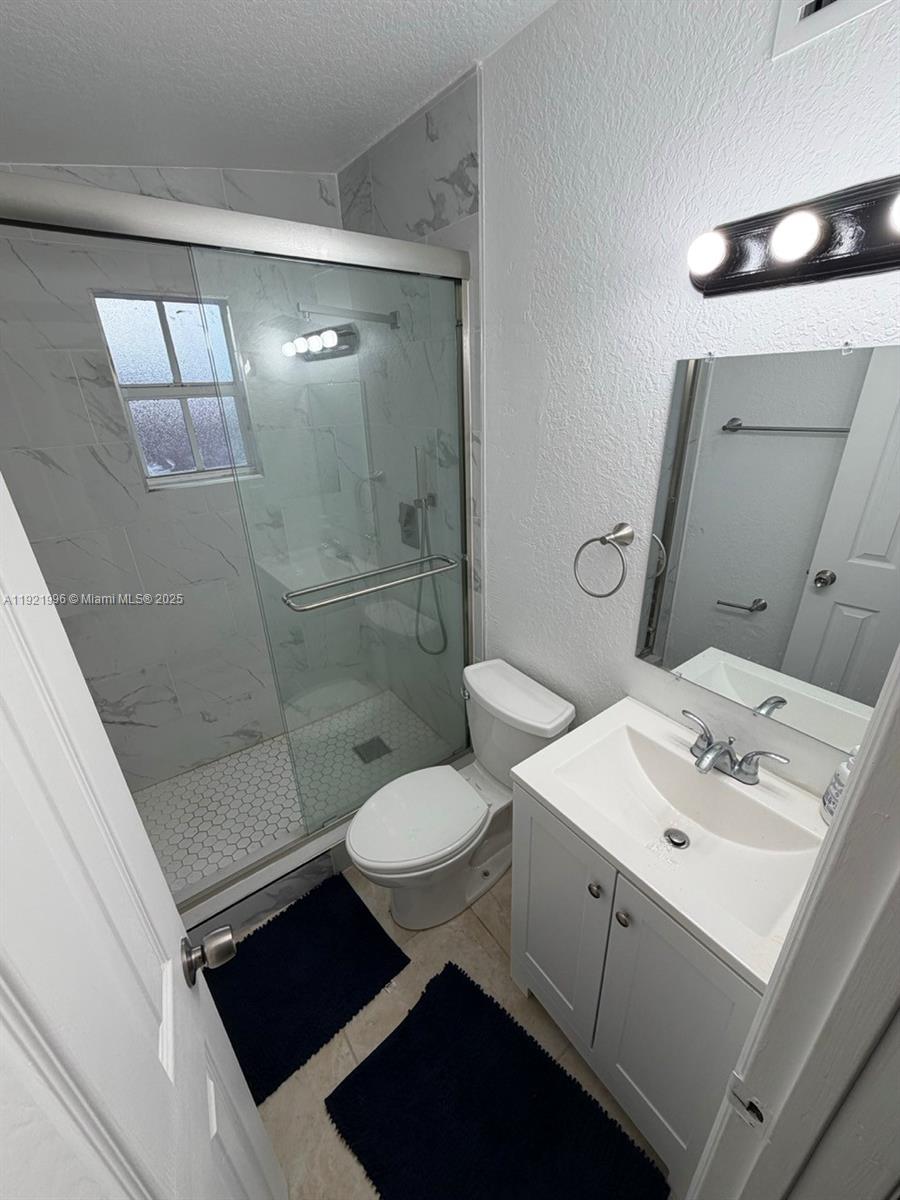 830 Southwest 6th Street, Unit B Hallandale Beach, FL 33009 - Photo 8 of 11 a bathroom with a sink toilet and shower