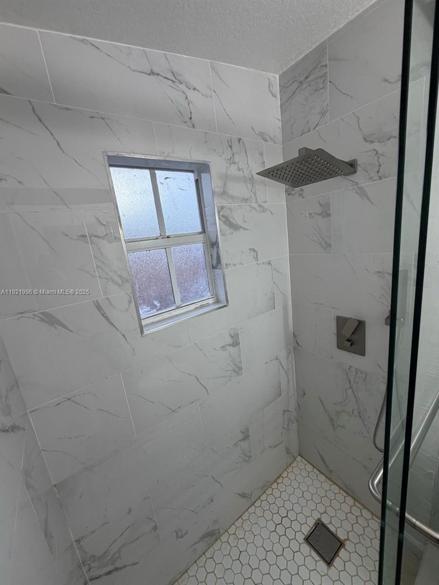 830 Southwest 6th Street, Unit B Hallandale Beach, FL 33009 - Photo 9 of 11 a bathroom with a shower