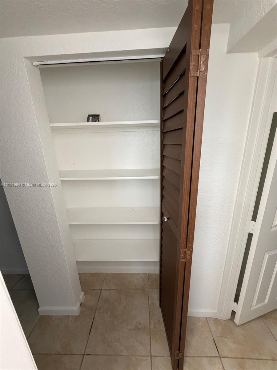 830 Southwest 6th Street, Unit B Hallandale Beach, FL 33009 - Photo 10 of 11 a view of walk in closet with empty racks