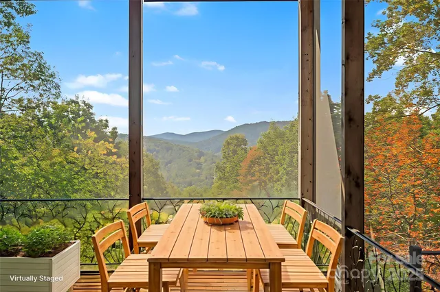 a view of a balcony with chairs and wooden floor