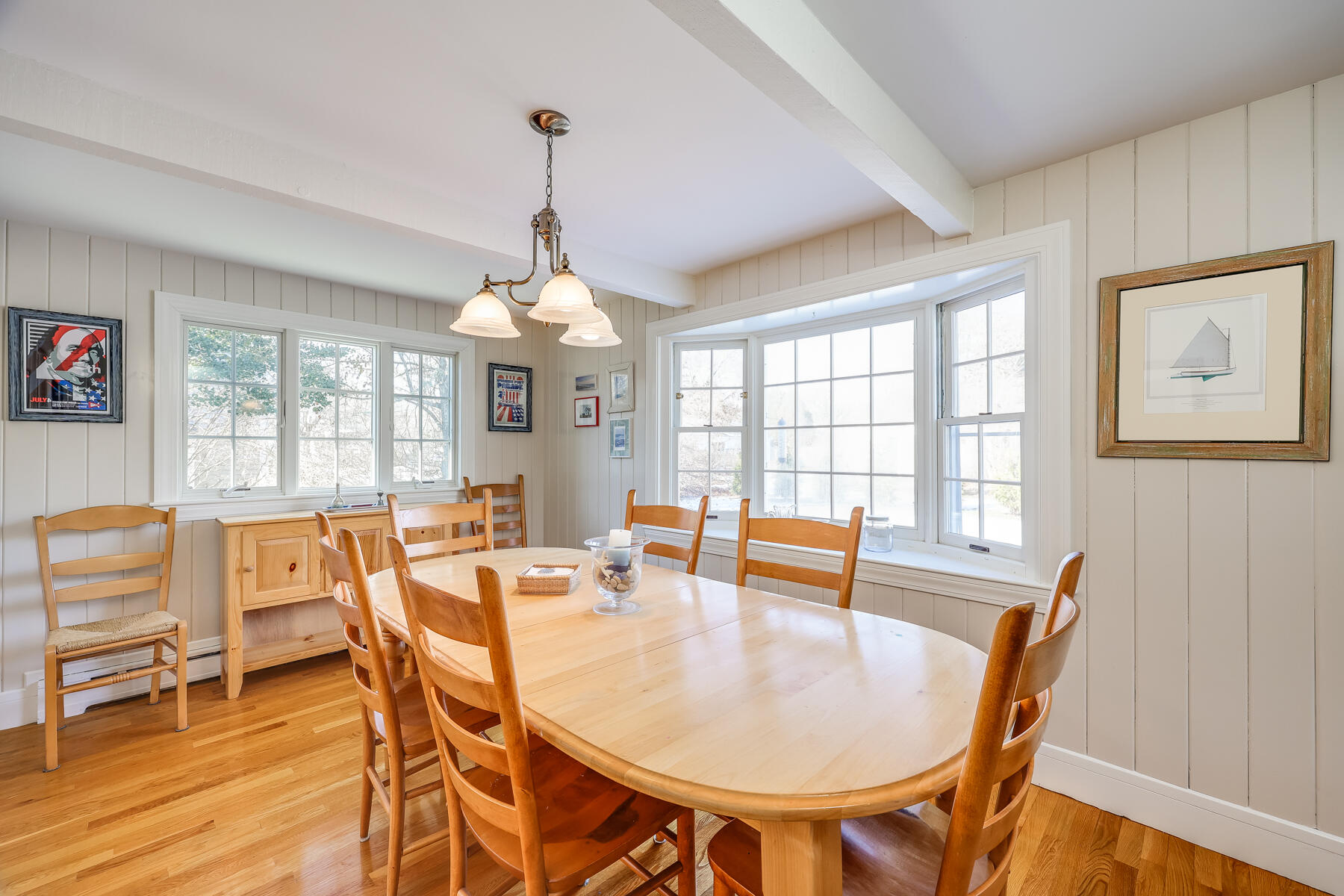 87 First Avenue Hyannis Port, MA 02601 - Photo 9 of 29 a dining room with furniture a chandelier and wooden floor