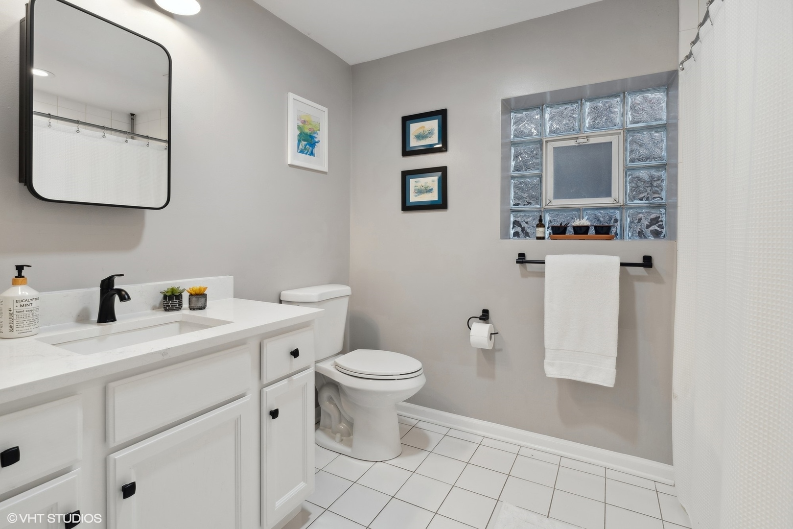 825 South Miller Street, Unit 2 Chicago, IL 60607 - Photo 12 of 15 a bathroom with a toilet sink and mirror