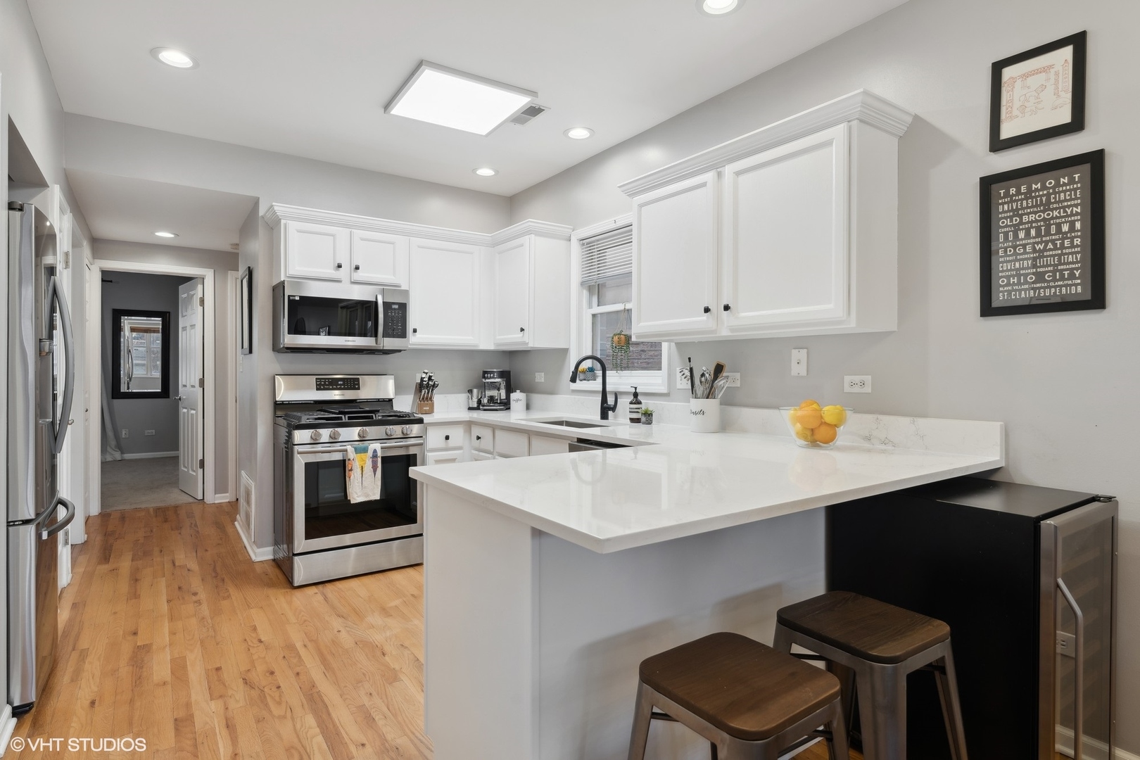 825 South Miller Street, Unit 2 Chicago, IL 60607 - Photo 7 of 15 a kitchen with kitchen island a sink cabinets and wooden floor