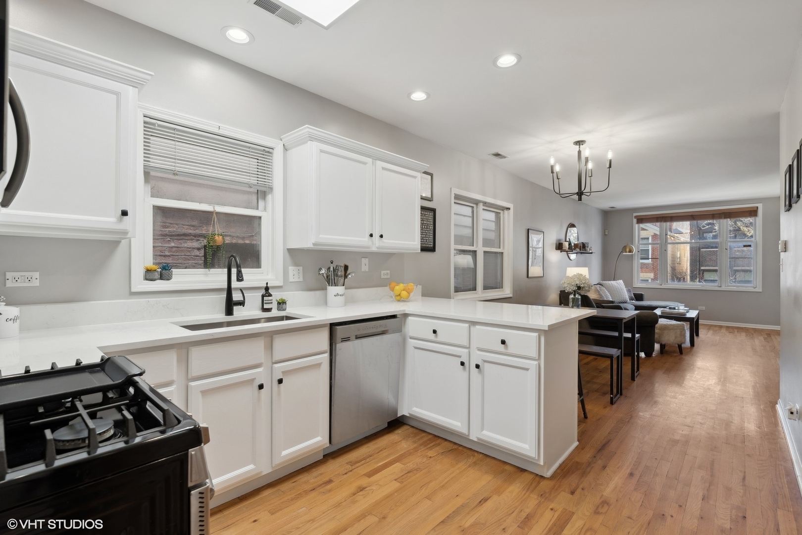 825 South Miller Street, Unit 2 Chicago, IL 60607 - Photo 9 of 15 a kitchen with a sink stove and wooden floor