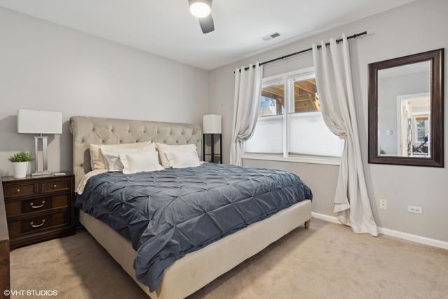 a large bed sitting in a bedroom next to a window