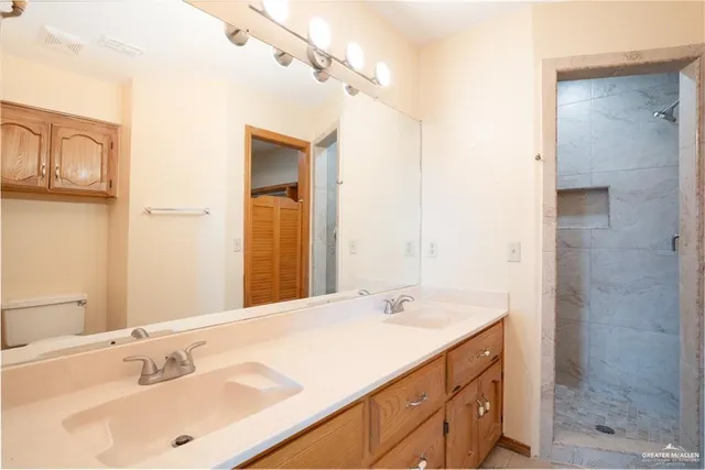 a bathroom with a shower sink and mirror