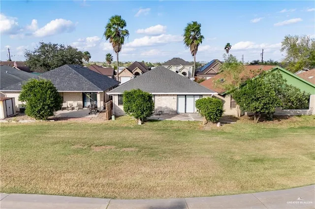 a front view of a house with a garden and yard