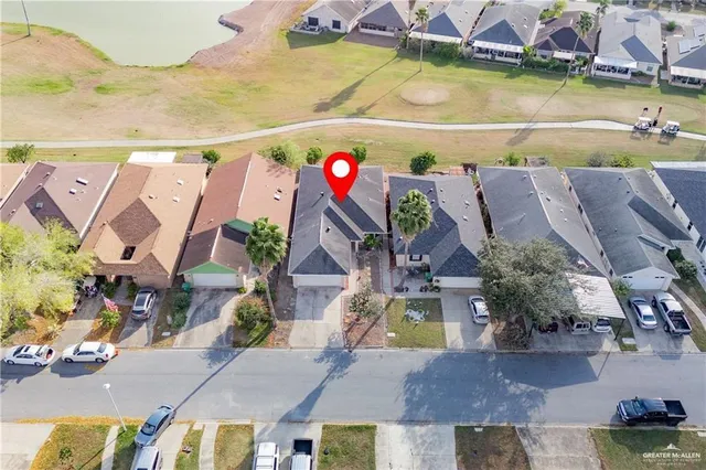 an aerial view of residential houses with outdoor space and swimming pool