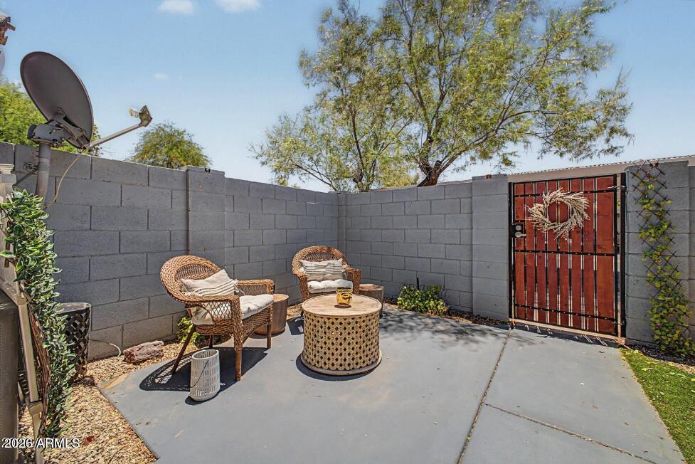 860 North McQueen Road, Unit 1135 Chandler, AZ 85225 - Photo 19 of 24 a view of a chairs and table in backyard