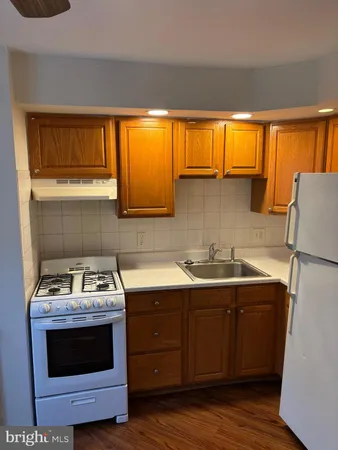 a kitchen with stainless steel appliances a stove a sink and a microwave