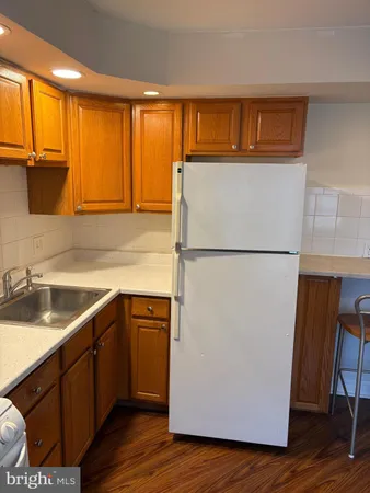 a kitchen with a refrigerator and a sink
