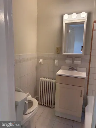 a bathroom with a sink a toilet and mirror