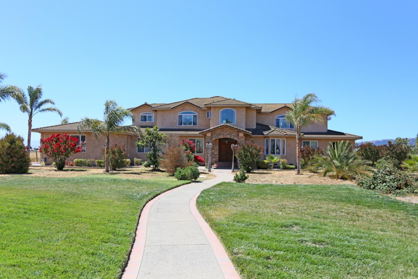 a front view of house with yard and green space