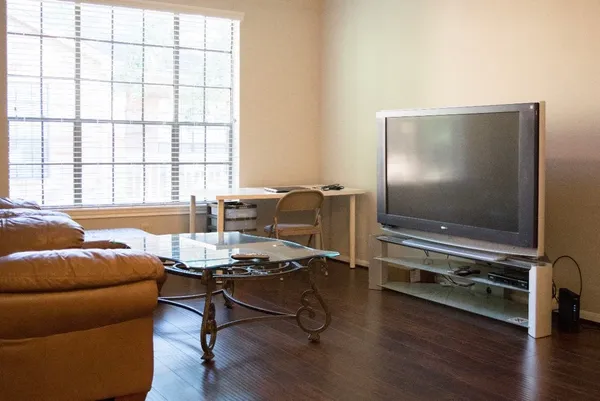 a living room with furniture and a flat screen tv