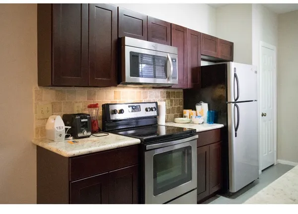 a kitchen with a sink a stove and refrigerator