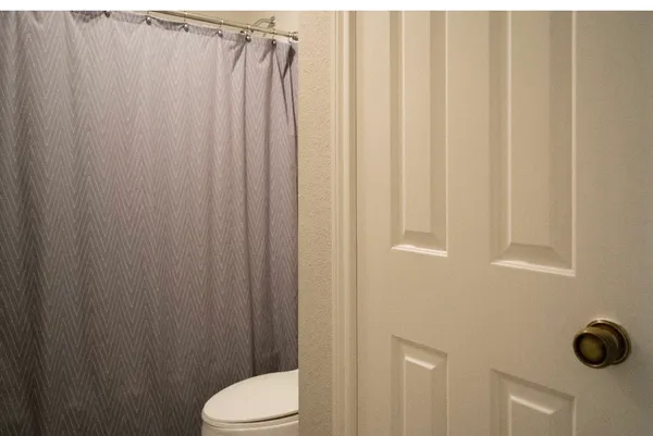 a bathroom with a shower curtain and sink