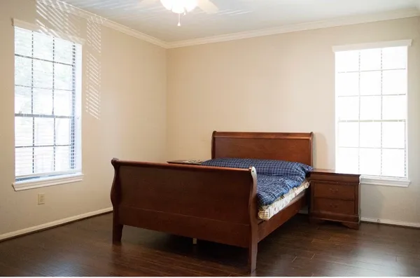 a bedroom with a bed and window