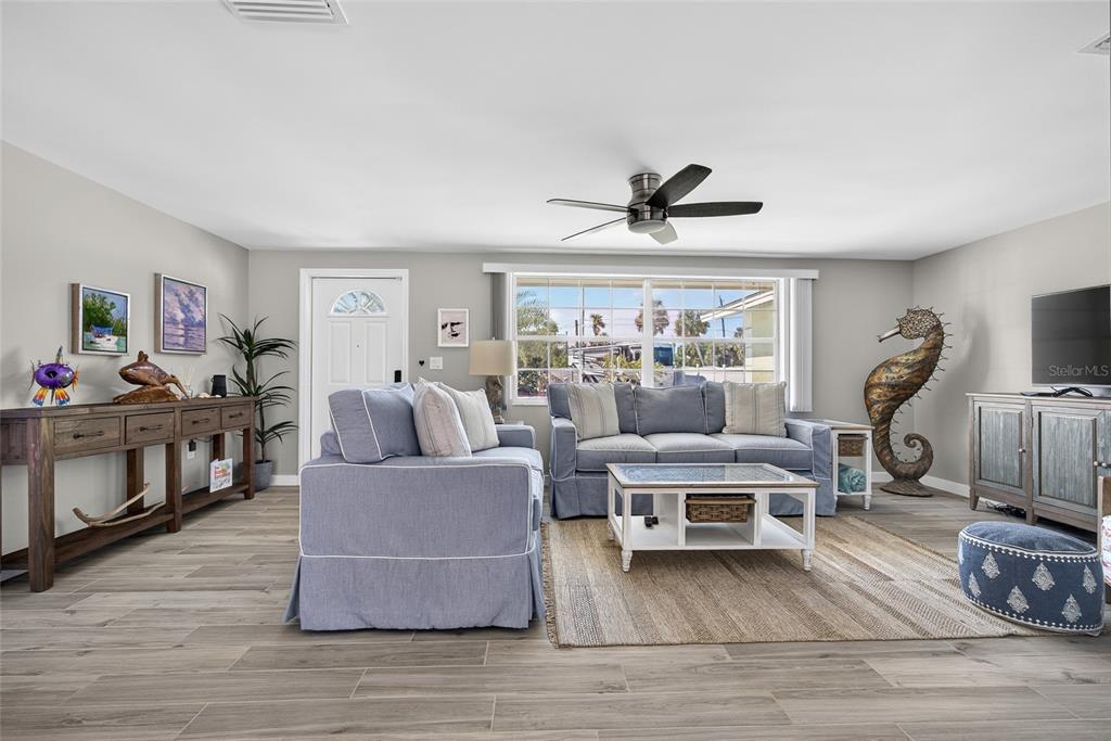 6035 Manasota Key Road Englewood, FL 34223 - Photo 11 of 54 a living room with furniture and a flat screen tv