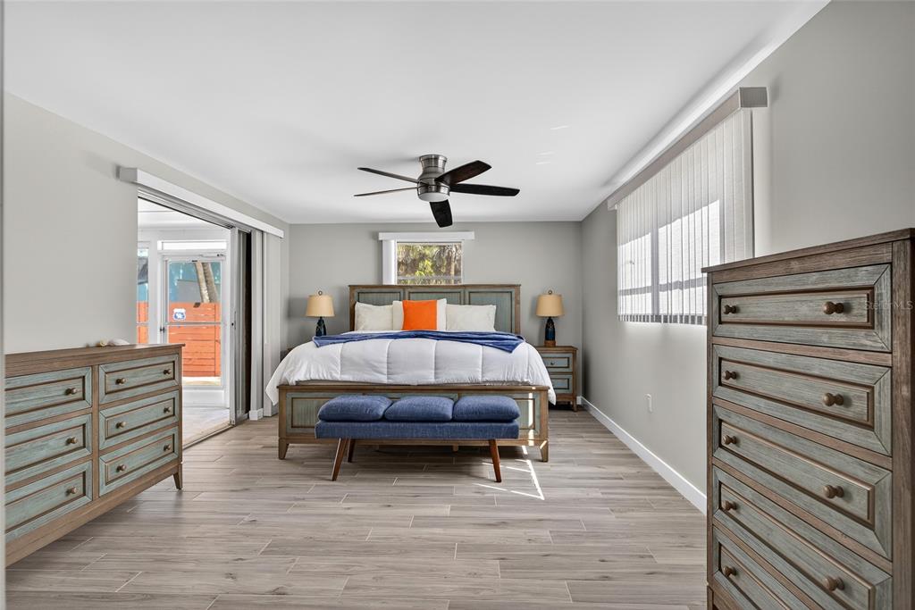 6035 Manasota Key Road Englewood, FL 34223 - Photo 18 of 54 a bedroom with a bed and wooden floor