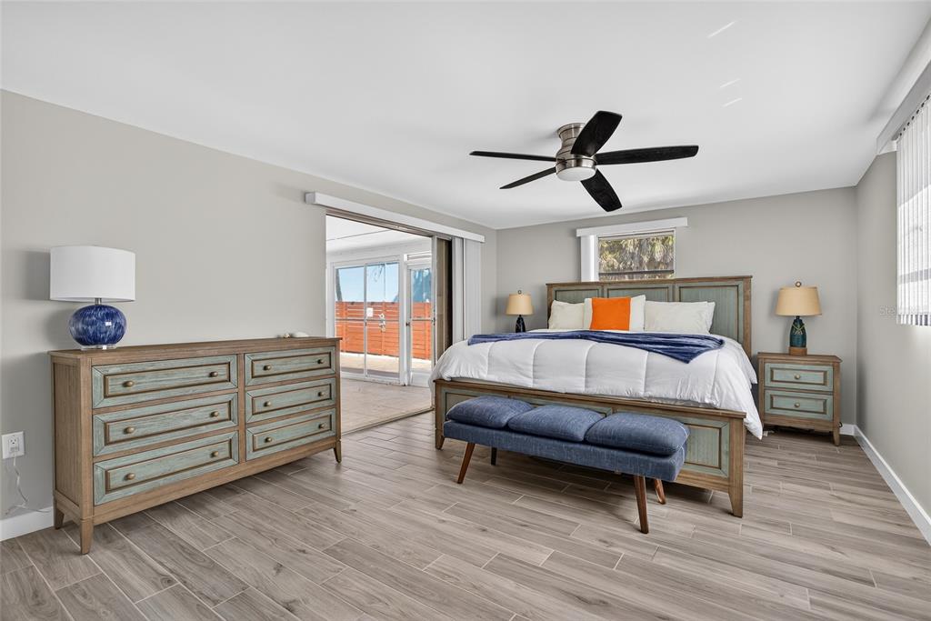 6035 Manasota Key Road Englewood, FL 34223 - Photo 19 of 54 a bedroom with a bed and wooden floor