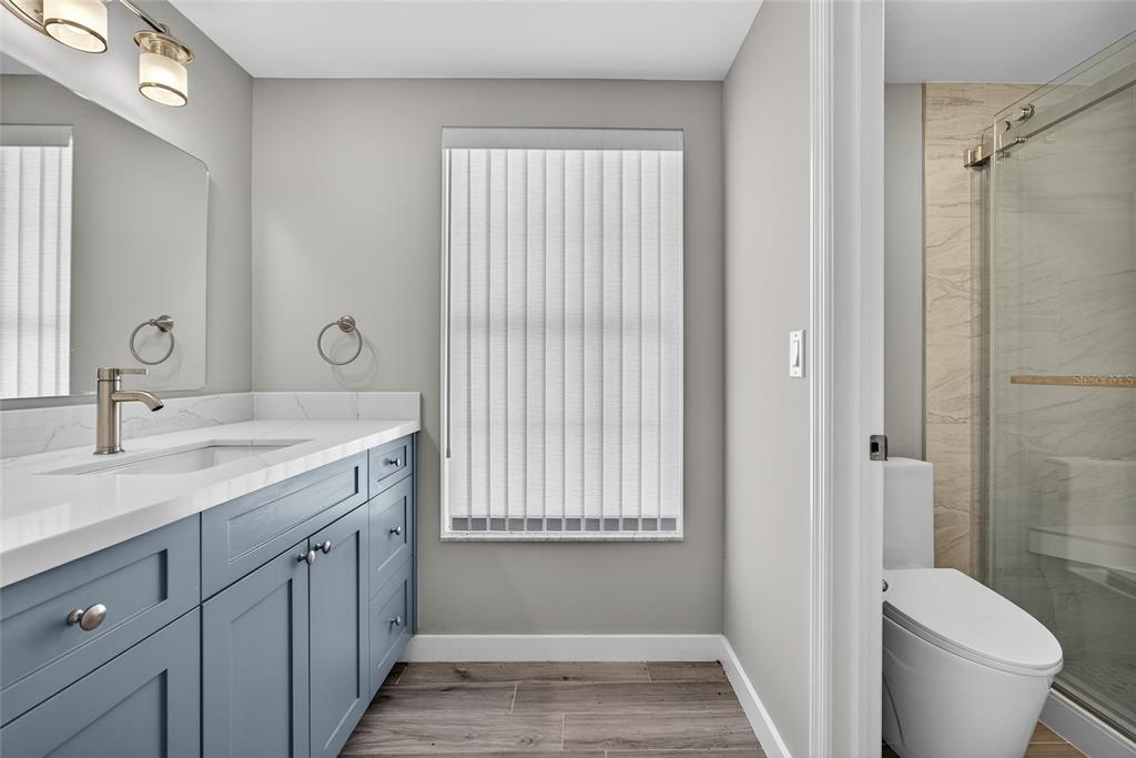 6035 Manasota Key Road Englewood, FL 34223 - Photo 21 of 54 a bathroom with a sink a toilet and shower