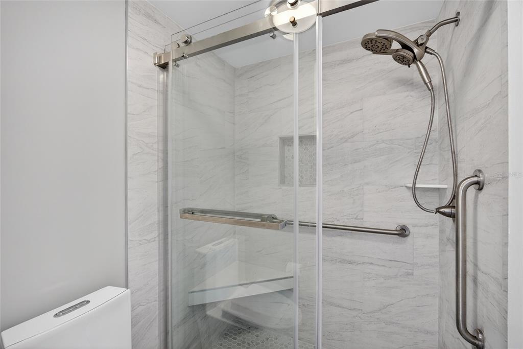 6035 Manasota Key Road Englewood, FL 34223 - Photo 23 of 54 a bathroom with a shower and toilet