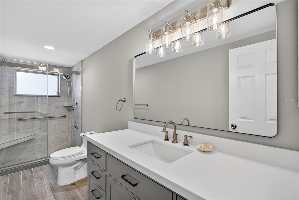 6035 Manasota Key Road Englewood, FL 34223 - Photo 26 of 54 a bathroom with a sink a toilet and mirror
