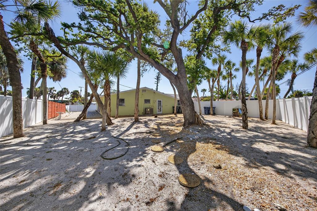 6035 Manasota Key Road Englewood, FL 34223 - Photo 33 of 54 a view of a yard with plants and a large tree