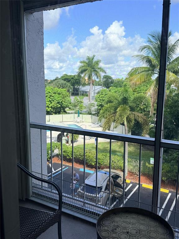 505 Spencer Drive, Unit 210 West Palm Beach, FL 33409 - Photo 3 of 12 a balcony with chairs