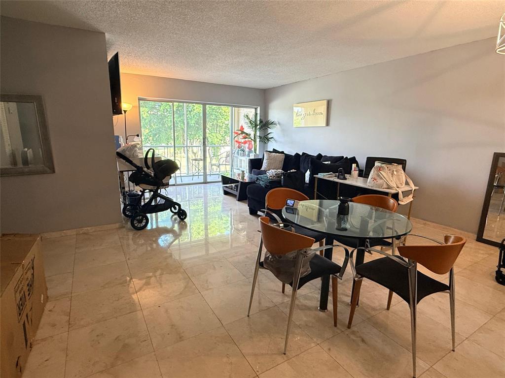 505 Spencer Drive, Unit 210 West Palm Beach, FL 33409 - Photo 5 of 12 a workspace with furniture and a large window